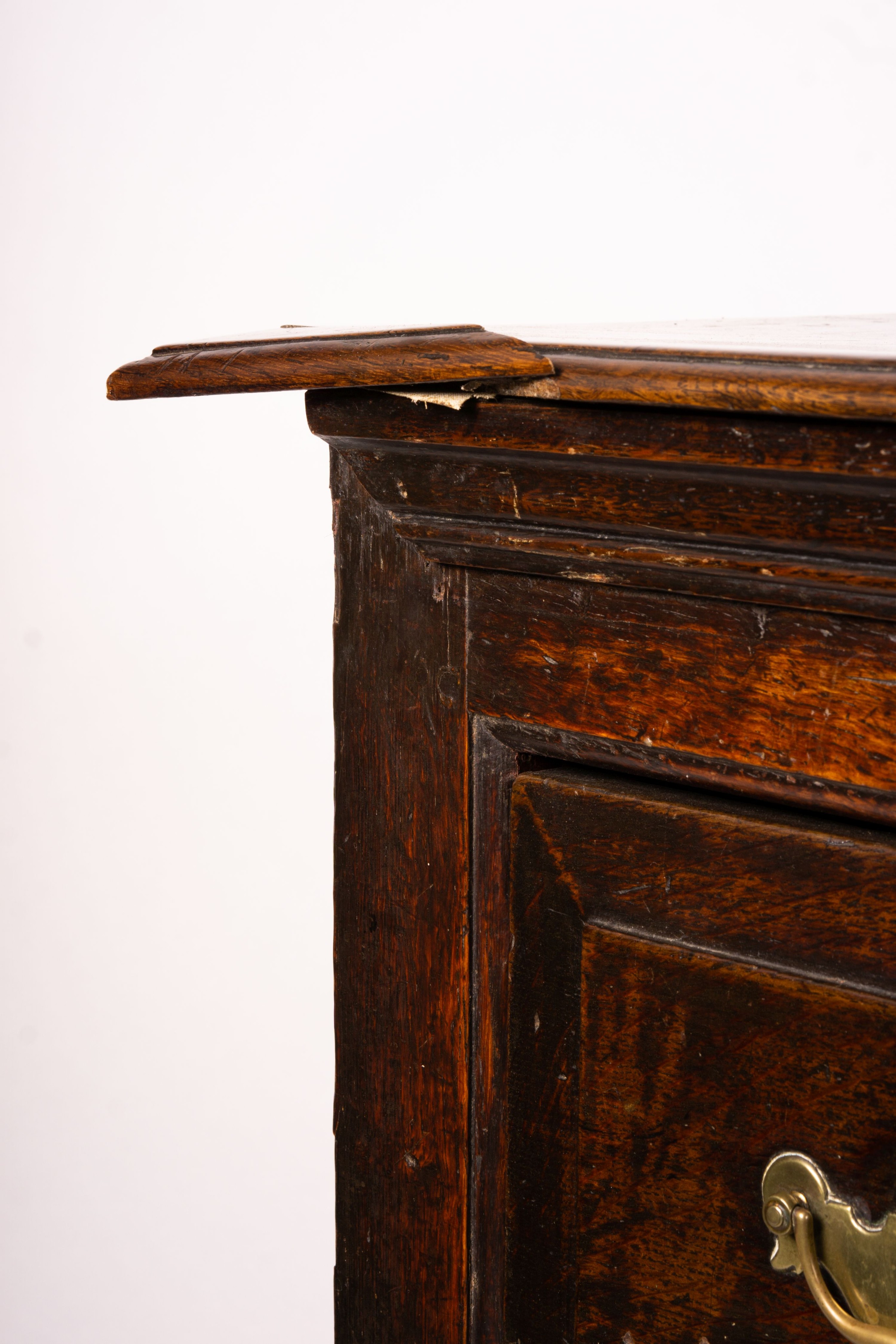 An 18th century oak low dresser on pole turned legs and pad feet, length 198cm, depth 53cm, height 88cm